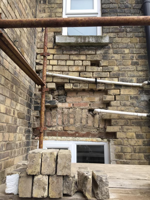 professionals remove existing bricks and repair with masonry stitching with steel reinforcement